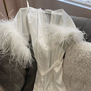 Very feminine white robe with ostrich feathers … super cute. Very sexy .